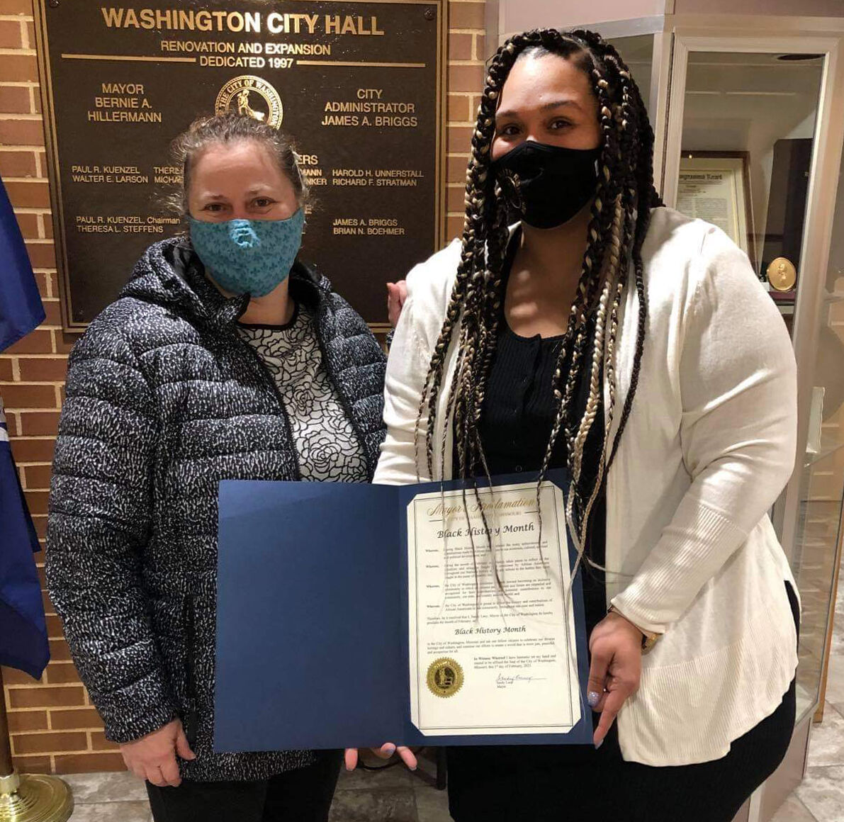 Aimee Appell and Alexandria Gray hold a proclamation